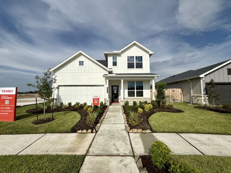 A beautiful white two-story home with manicured landscaping in The Courtyards at Stokesbury by Centex (Waller, TX). A beautiful white two-story home with manicured landscaping in The Courtyards at Stokesbury by Centex (Waller, TX).