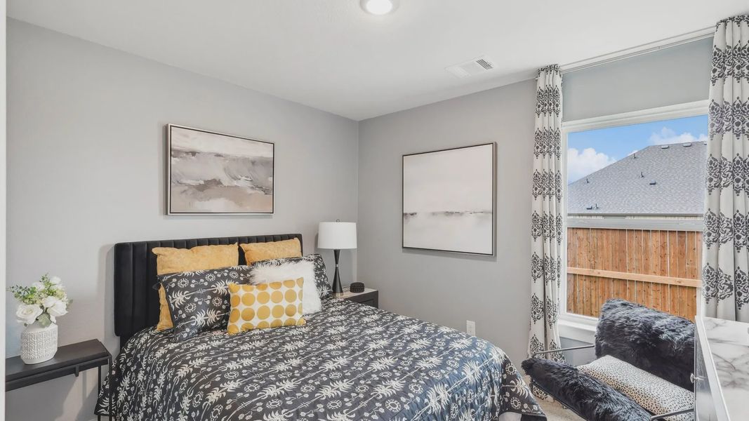 Experience luxury in a modern bedroom with stylish patterns and abundant natural light in Still Water Lake Estates.