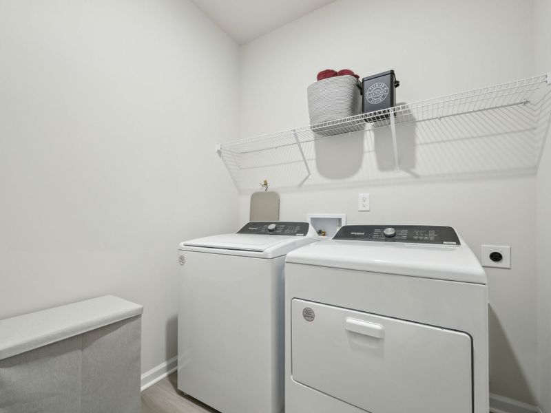 A sizeable laundry room provides extra storage space.