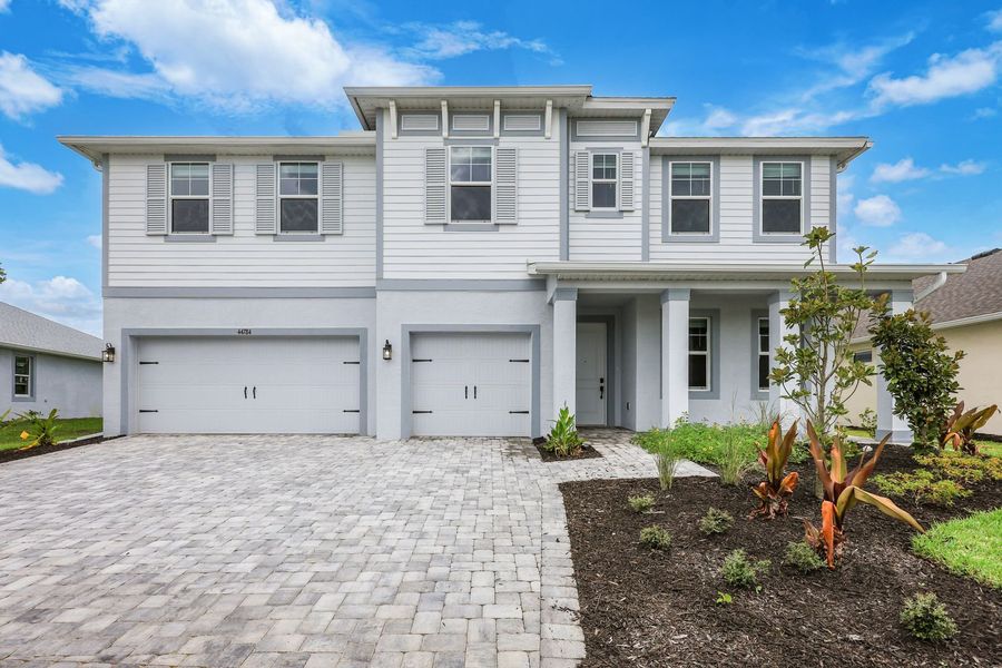 Front exterior of a home in the Tamarack at Two Rivers community, located in Zephyrhills, FL (Image 15).
