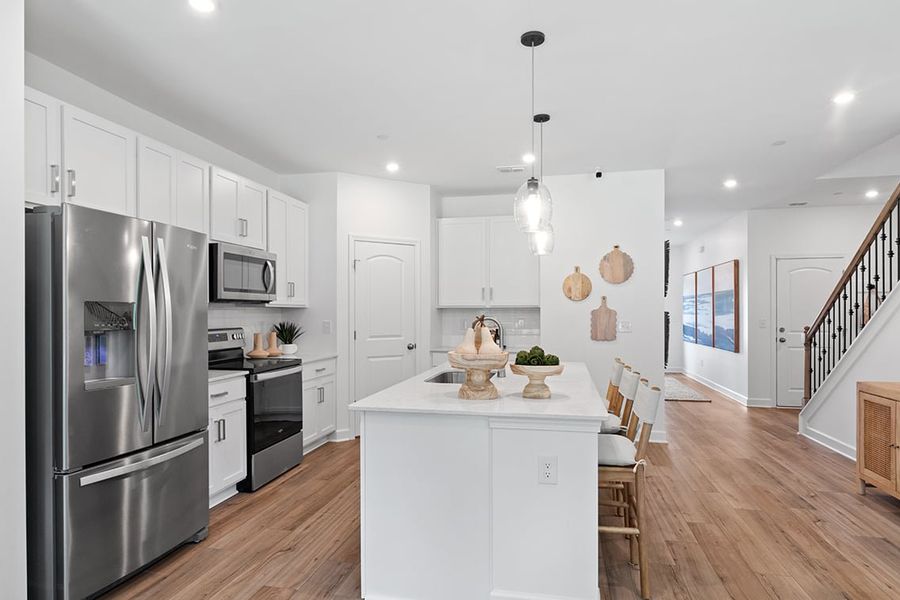 A kitchen with white cabinets. A kitchen with white cabinets.