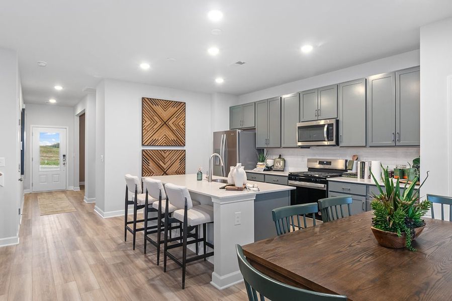 A kitchen with a dining table and chairs. A kitchen with a dining table and chairs.