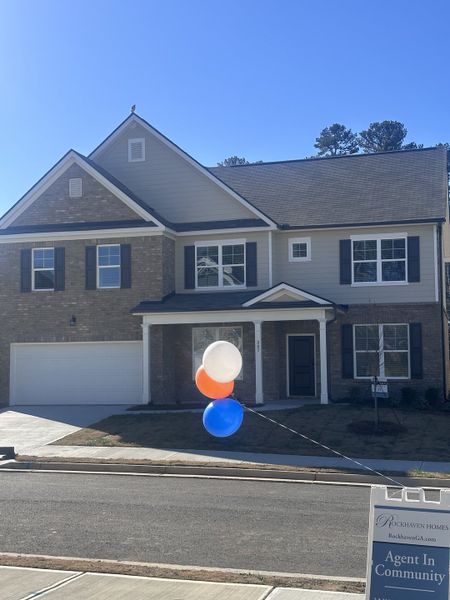 A charming brick home with a welcoming porch in Alcovy Village by Rockhaven Homes (Lawrenceville, GA).