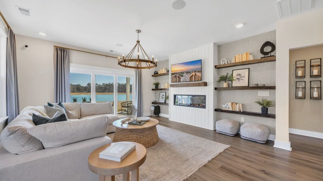 open concept living room in Chestnut Farms in by DRB homes offering lots of seating and a cozy environment