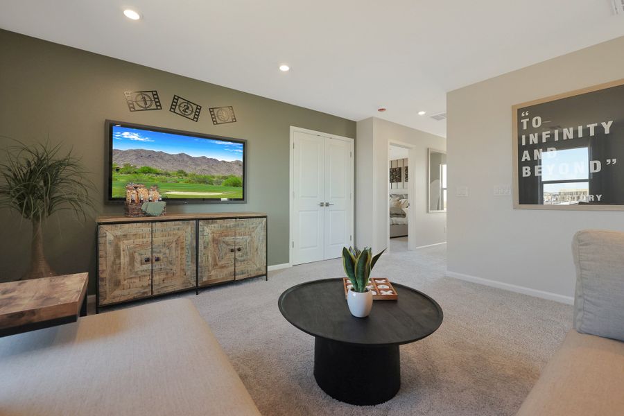 A living room with a tv and couches. A living room with a tv and couches.