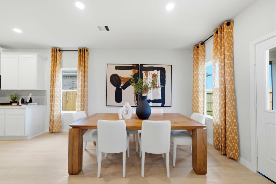 A dining room with a table and chairs. A dining room with a table and chairs.
