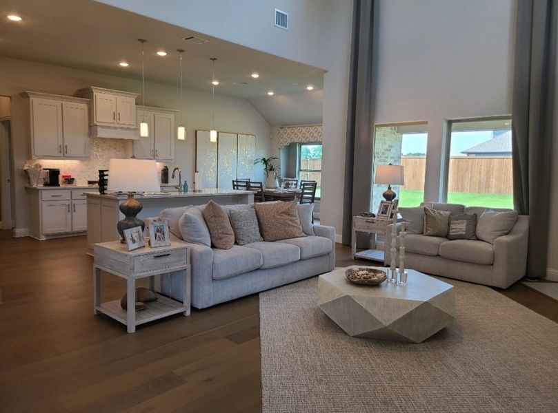 A spacious open-concept living room with cozy sofas, a sleek kitchen, and abundant natural light. A spacious open-concept living room with cozy sofas, a sleek kitchen, and abundant natural light.