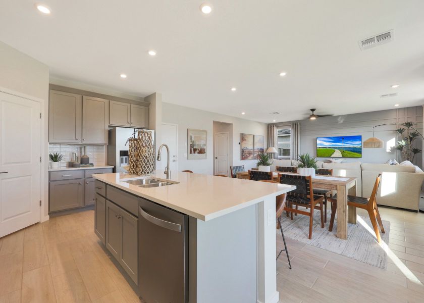 A kitchen with white cabinets.