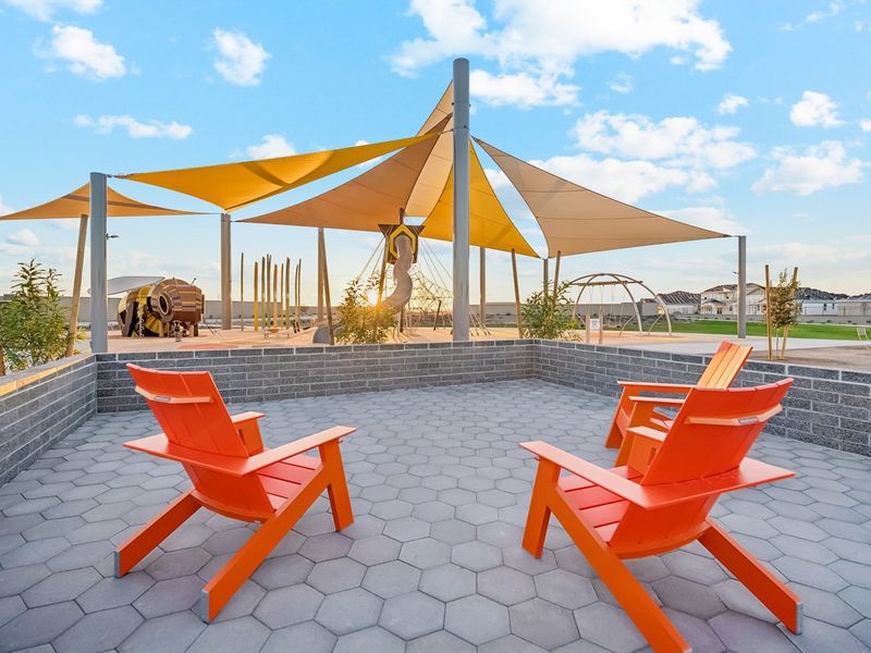 A couple of chairs on a patio. A couple of chairs on a patio.