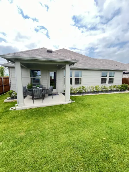 A charming home with a cozy patio and lush lawn in Simpson Crossing - Signature Series by Meritage Homes (McKinney, TX). A charming home with a cozy patio and lush lawn in Simpson Crossing - Signature Series by Meritage Homes (McKinney, TX).