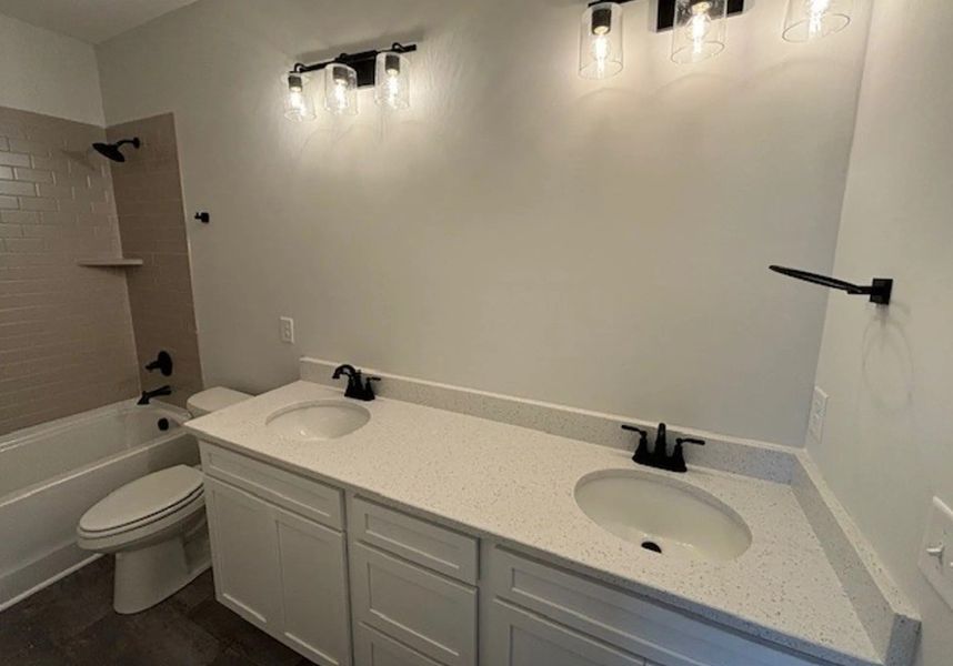 Secondary bathrooms that host tile surround showers and quartz countertops Secondary bathrooms that host tile surround showers and quartz countertops