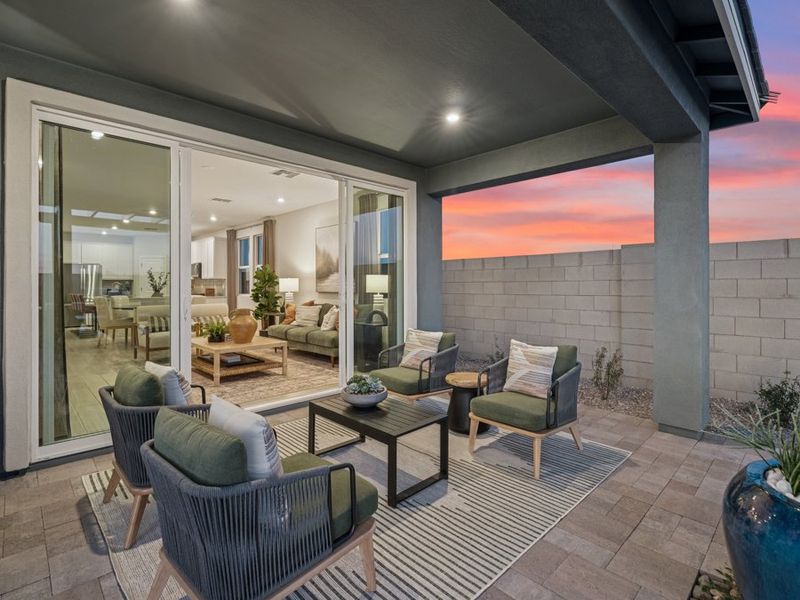 A living room with a patio and a large glass door. A living room with a patio and a large glass door.