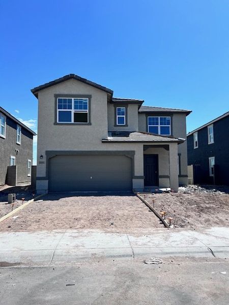 A modern two-story home with a spacious garage in Agave Trails by Starlight Homes (Buckeye, AZ). A modern two-story home with a spacious garage in Agave Trails by Starlight Homes (Buckeye, AZ).