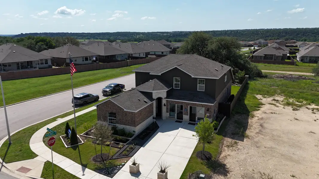 A modern two-story home with a spacious driveway in Lively Ranch: Claremont Collection by Lennar (Georgetown, TX).