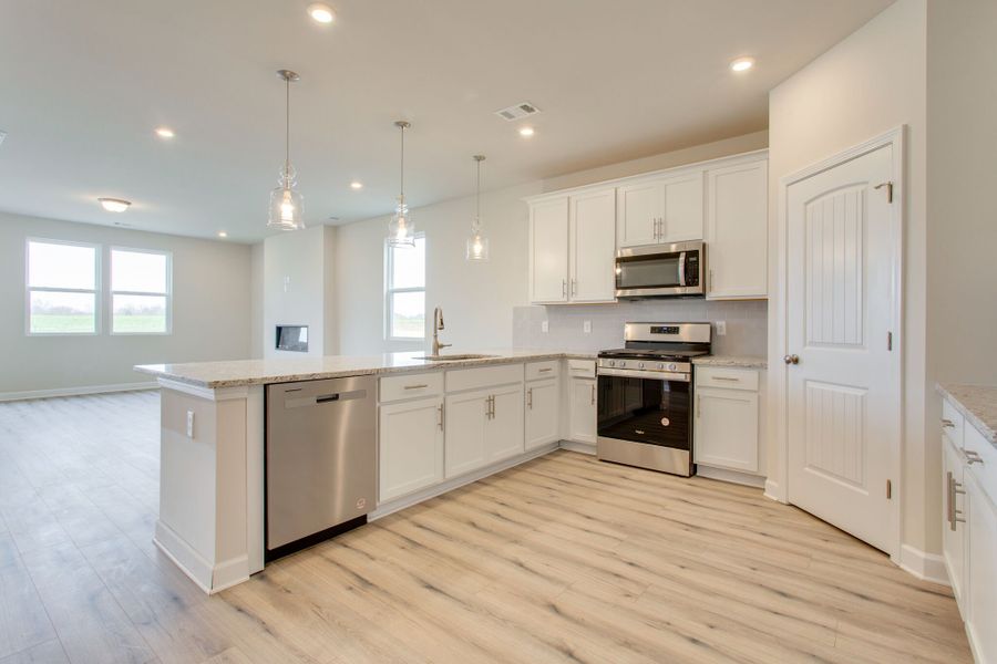 A kitchen with white cabinets. A kitchen with white cabinets.