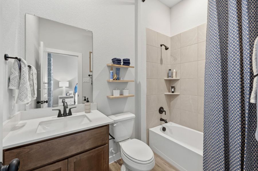 A bathroom with a tub toilet and sink. A bathroom with a tub toilet and sink.