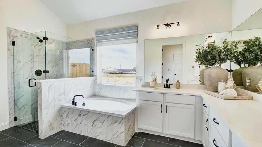 Elegant glass shower and marble tiles create a luxurious ambiance in this Veranda home.