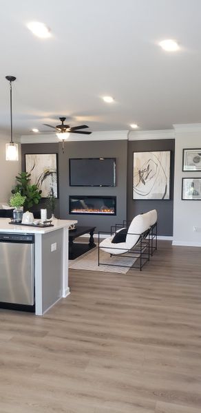 A modern living area with a sleek electric fireplace, stylish artwork, cozy seating, and chic lighting fixtures. A modern living area with a sleek electric fireplace, stylish artwork, cozy seating, and chic lighting fixtures.