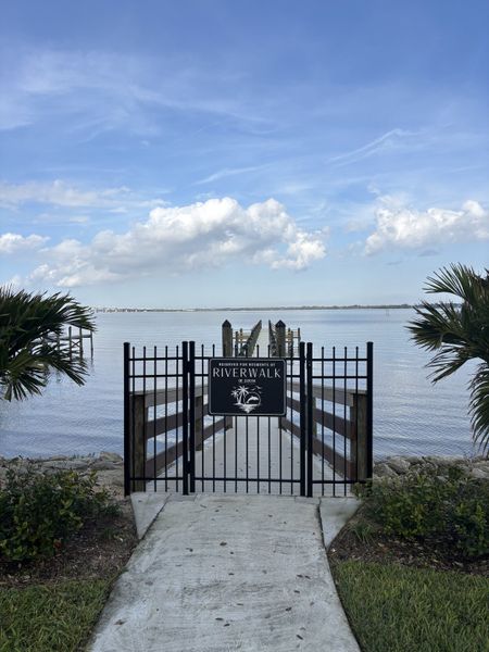 Scenic view of a private dock at Riverwalk of Cocoa, leading to a calm riverfront.