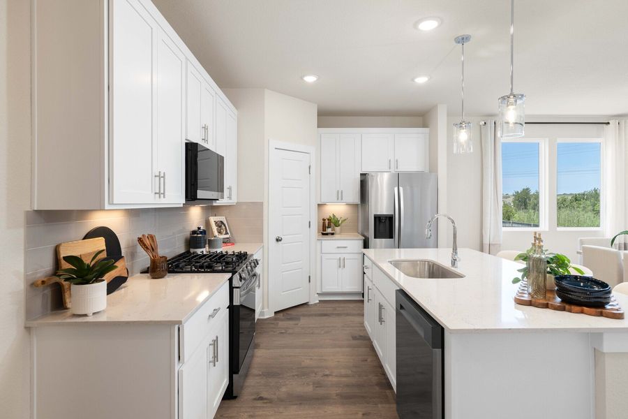 A kitchen with white cabinets.