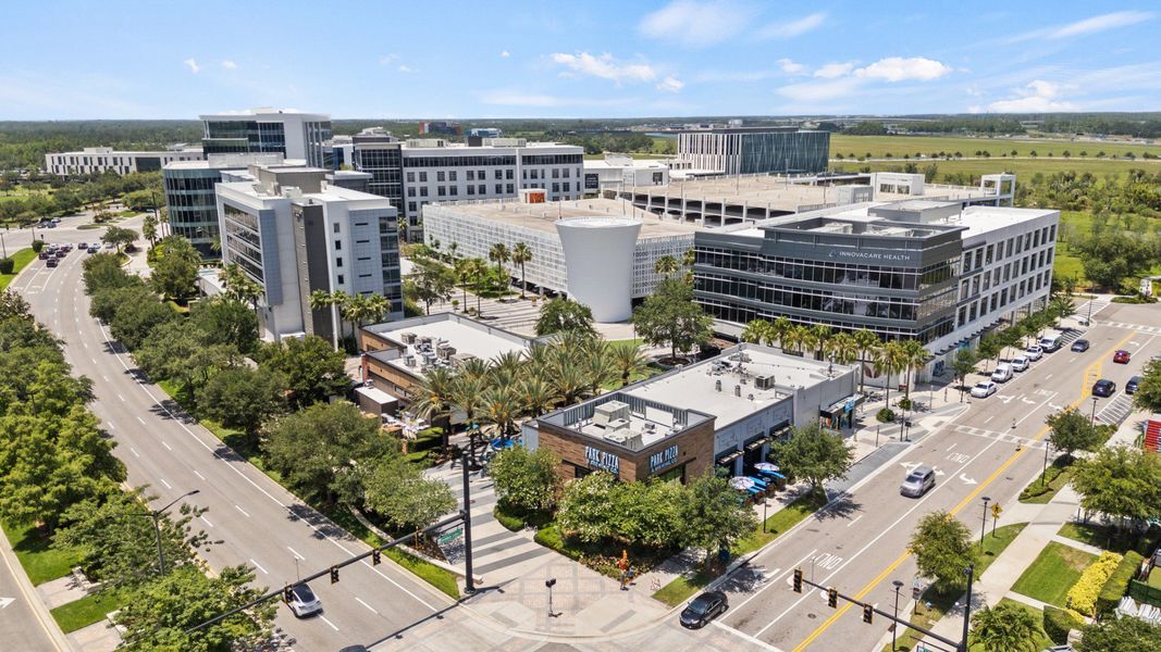 Aerial view of Lake Nona Town Center in Orlando, FL a hub for shopping, dining, and business near DRB Homes Cyrene at Harmony Aerial view of Lake Nona Town Center in Orlando, FL a hub for shopping, dining, and business near DRB Homes Cyrene at Harmony
