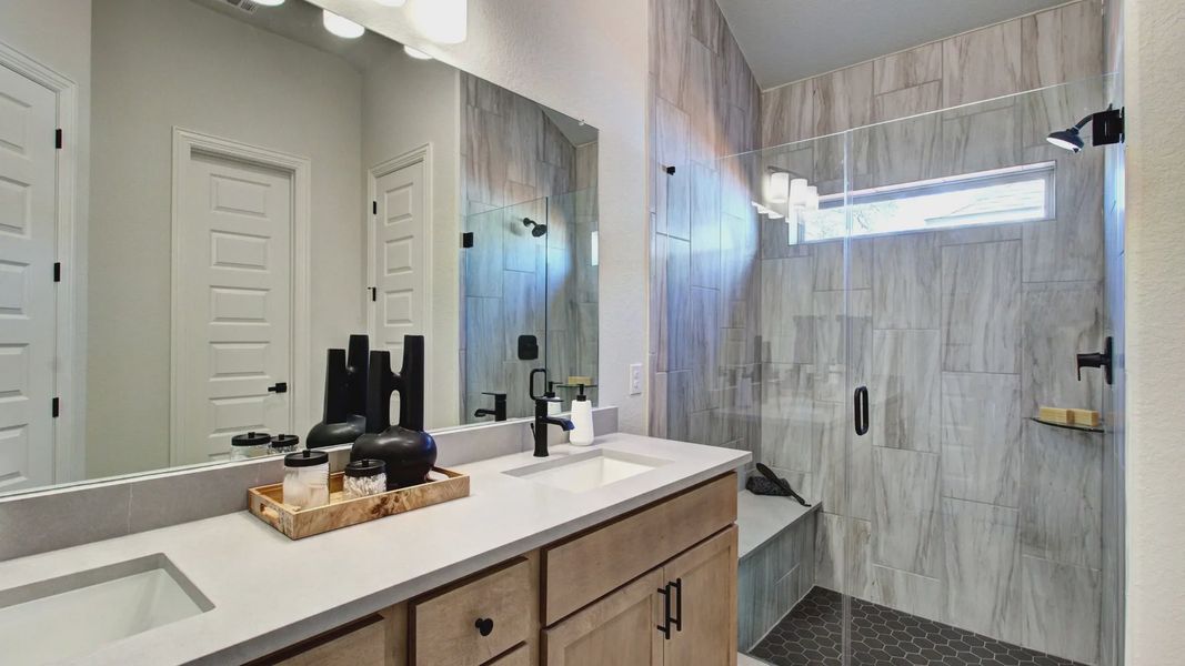 Experience opulence with dual sinks, elegant marble texture, and a glass shower at Meyer Ranch. Experience opulence with dual sinks, elegant marble texture, and a glass shower at Meyer Ranch.
