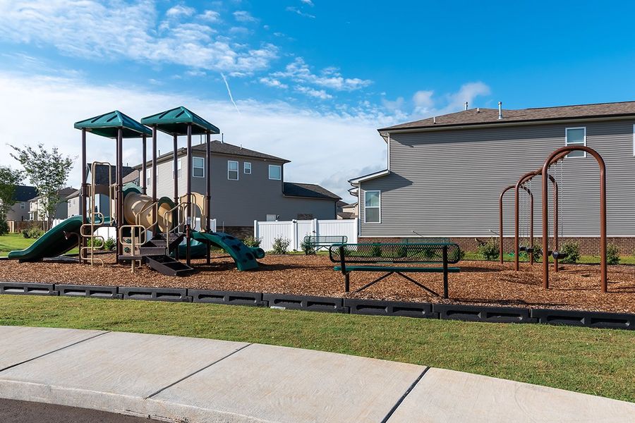 A playground in front of a building. A playground in front of a building.