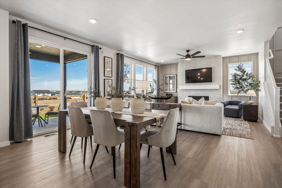A large living room with a large dining table and large windows. A large living room with a large dining table and large windows.