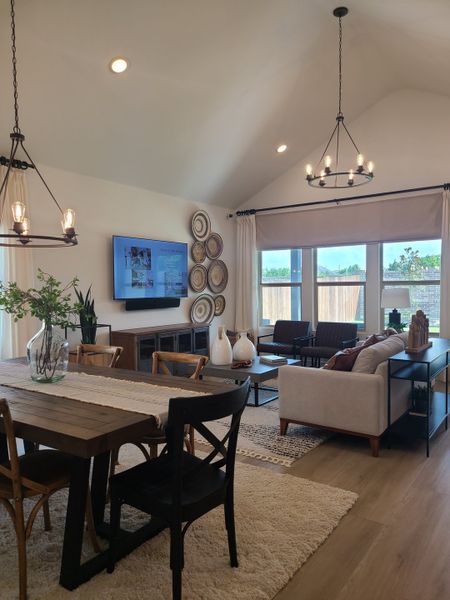 An inviting living area with vaulted ceilings, elegant chandeliers, and cozy seating, perfect for entertaining and relaxation. An inviting living area with vaulted ceilings, elegant chandeliers, and cozy seating, perfect for entertaining and relaxation.
