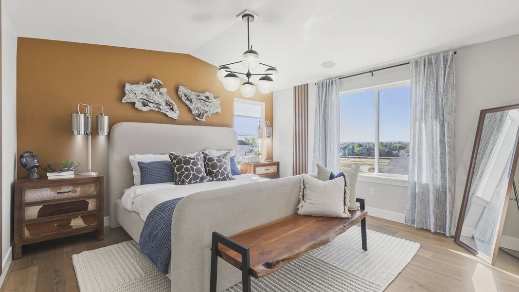 Elegant master bedroom features chic wood accents and panoramic views in Dillon Pointe. Elegant master bedroom features chic wood accents and panoramic views in Dillon Pointe.