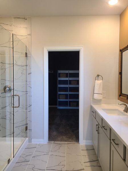 A modern bathroom with marble floors, a glass shower, sleek cabinetry, and bright lighting for a fresh, inviting feel. A modern bathroom with marble floors, a glass shower, sleek cabinetry, and bright lighting for a fresh, inviting feel.