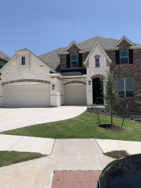 A beautiful two-story home with stone and brick accents in Retreat at San Gabriel by Brightland Homes (Georgetown, TX). A beautiful two-story home with stone and brick accents in Retreat at San Gabriel by Brightland Homes (Georgetown, TX).