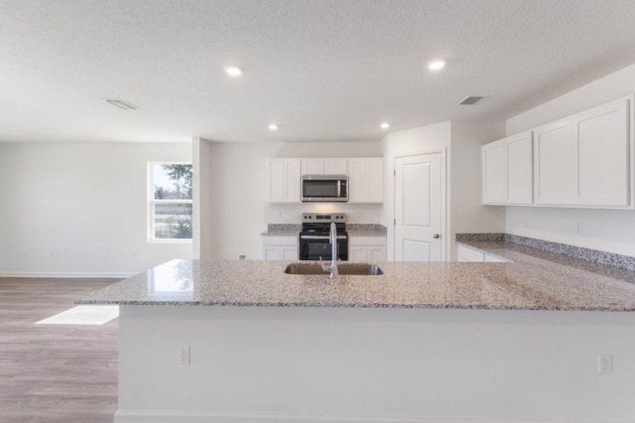 A kitchen with white cabinets. A kitchen with white cabinets.