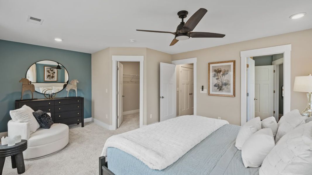 Plush carpeted primary suite with walk-in closet in two story townhome at Ransdell Pointe by DRB Homes in Spartanburg, SC
