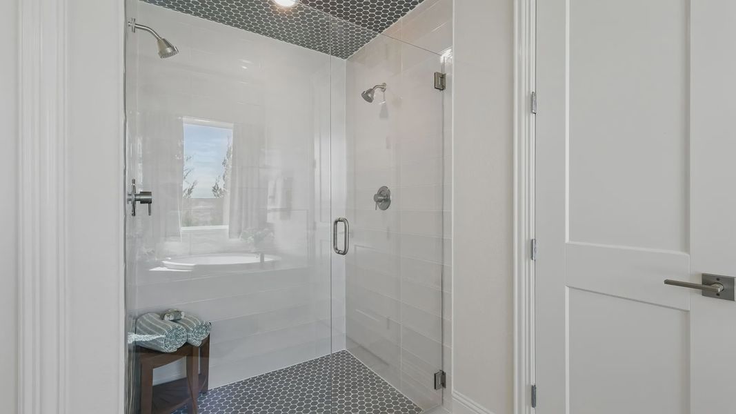 Sophisticated shower with hexagonal tiles and premium fixtures in Kelly Ranch’s Rio Vista enclave. Sophisticated shower with hexagonal tiles and premium fixtures in Kelly Ranch’s Rio Vista enclave.