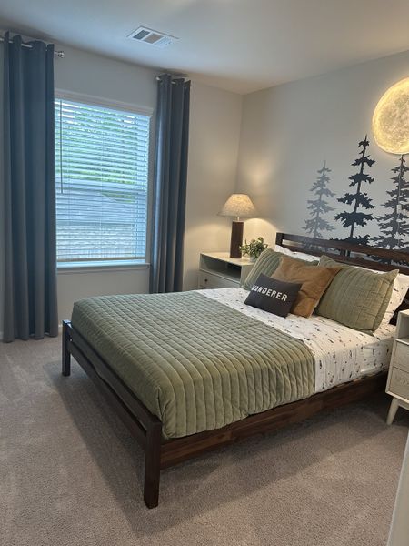 A serene bedroom with forest-themed art, cozy bedding, and soft lighting, creating a tranquil retreat. A serene bedroom with forest-themed art, cozy bedding, and soft lighting, creating a tranquil retreat.