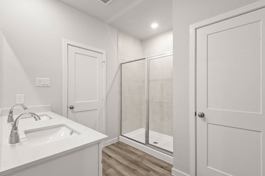 A bathroom with a glass shower. A bathroom with a glass shower.