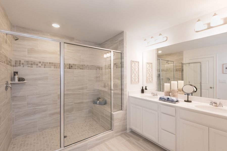 Private ensuite bathroom with a walk-in shower and dual vanity sinks.