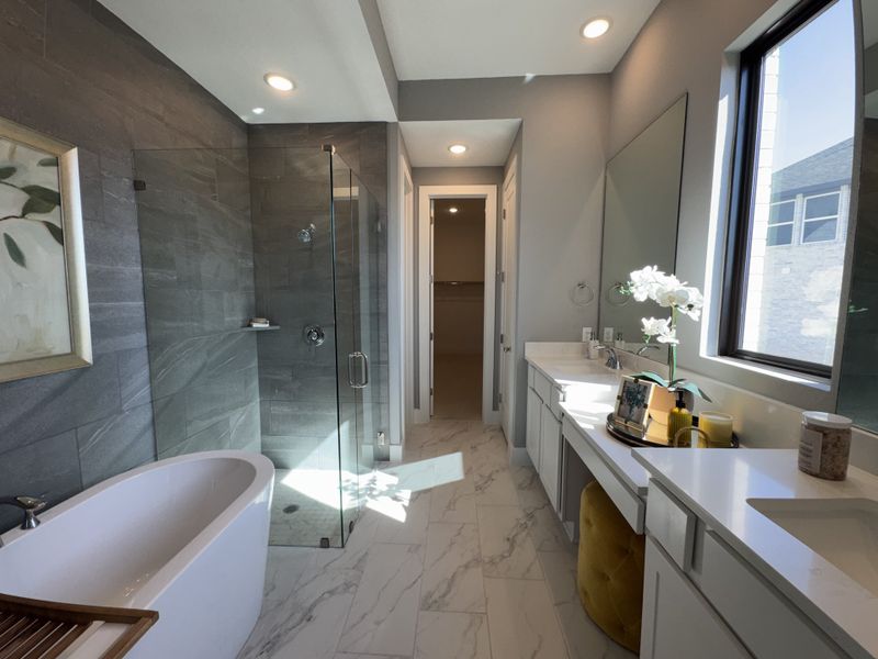 A luxurious bathroom featuring a freestanding tub, glass shower, dual vanity, and elegant lighting. A luxurious bathroom featuring a freestanding tub, glass shower, dual vanity, and elegant lighting.
