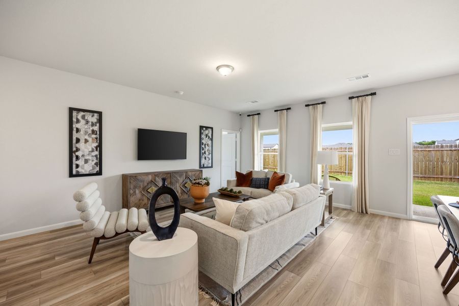 A living room with a large window. A living room with a large window.