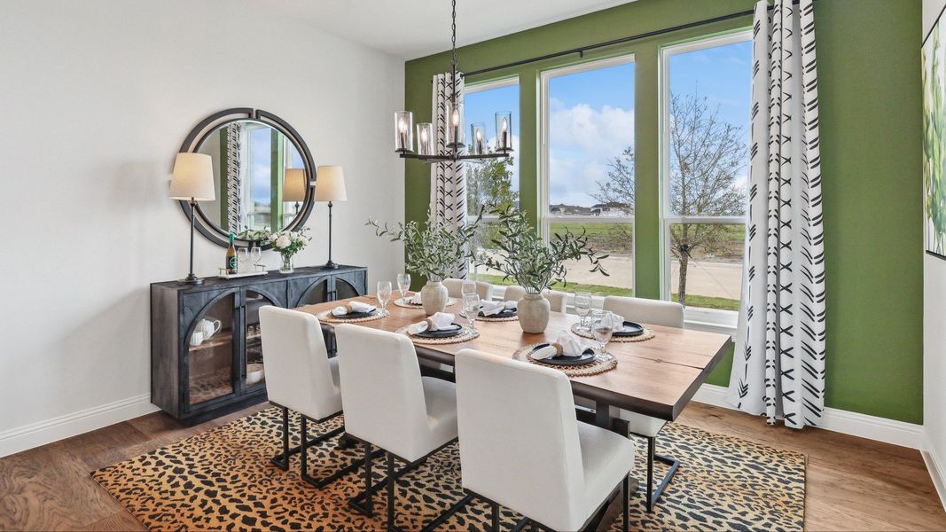 Experience refined elegance with a wood table, plush seating, and expansive windows in Green Meadows.