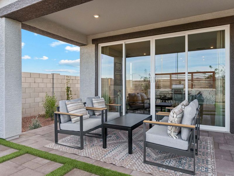 A patio with a table and chairs.