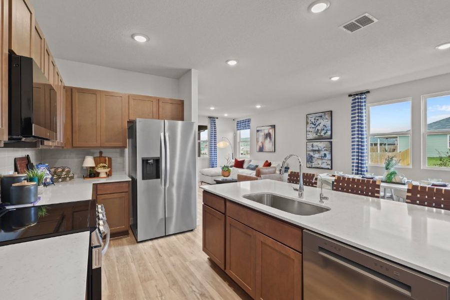 A kitchen with wooden cabinets.