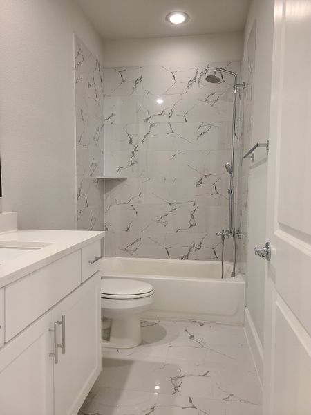 A modern bathroom featuring marble-patterned tiles, sleek countertops, and elegant fixtures for a luxurious feel. A modern bathroom featuring marble-patterned tiles, sleek countertops, and elegant fixtures for a luxurious feel.