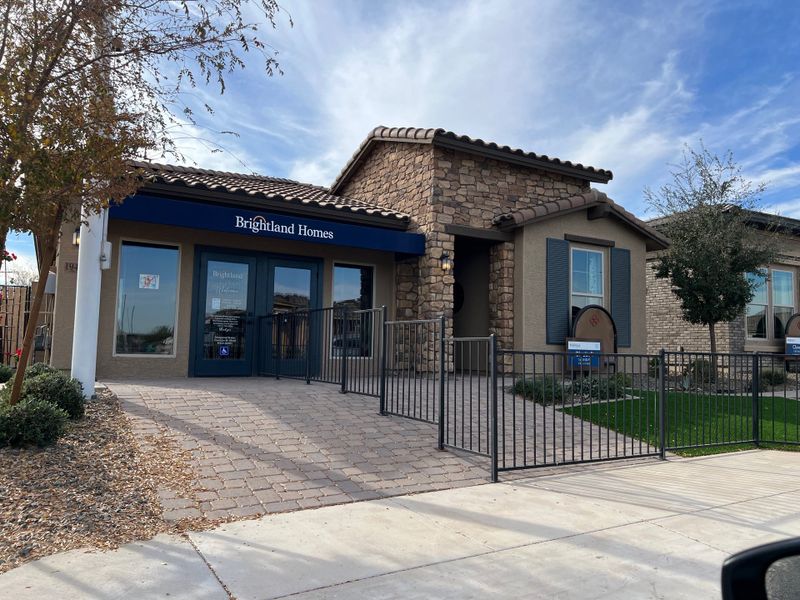 A charming brick and stone home at IronWing at Windrose by Brightland Homes, featuring a gated entrance (Litchfield Park, AZ). A charming brick and stone home at IronWing at Windrose by Brightland Homes, featuring a gated entrance (Litchfield Park, AZ).
