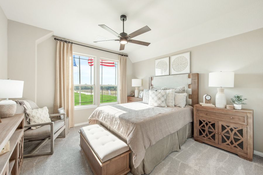 Bedroom with king bed, ceiling fan, wood furniture, and window with outdoor view Bedroom with king bed, ceiling fan, wood furniture, and window with outdoor view