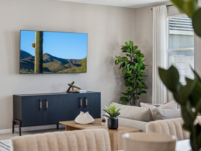 A room with a table and plants.