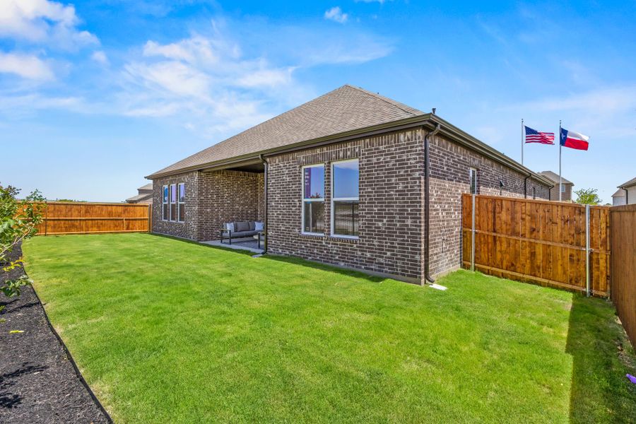 A brick house with flags on the side. A brick house with flags on the side.