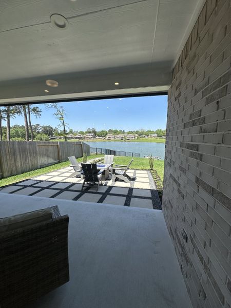 A serene patio with modern seating and stunning lake views, perfect for relaxation and outdoor gatherings.