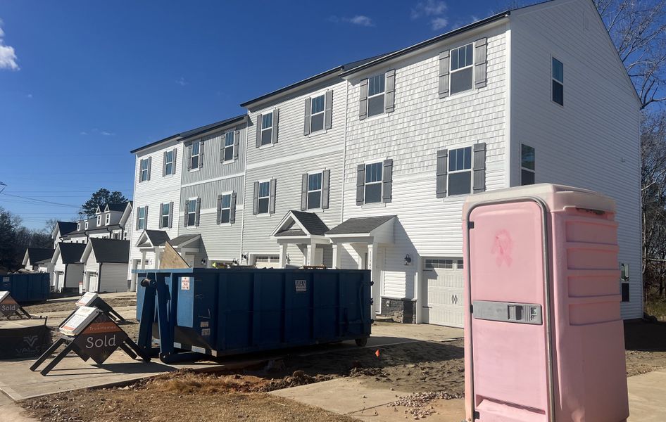 A modern white townhouse under development in The Landings at Catawba River by True Homes (Charlotte, NC).